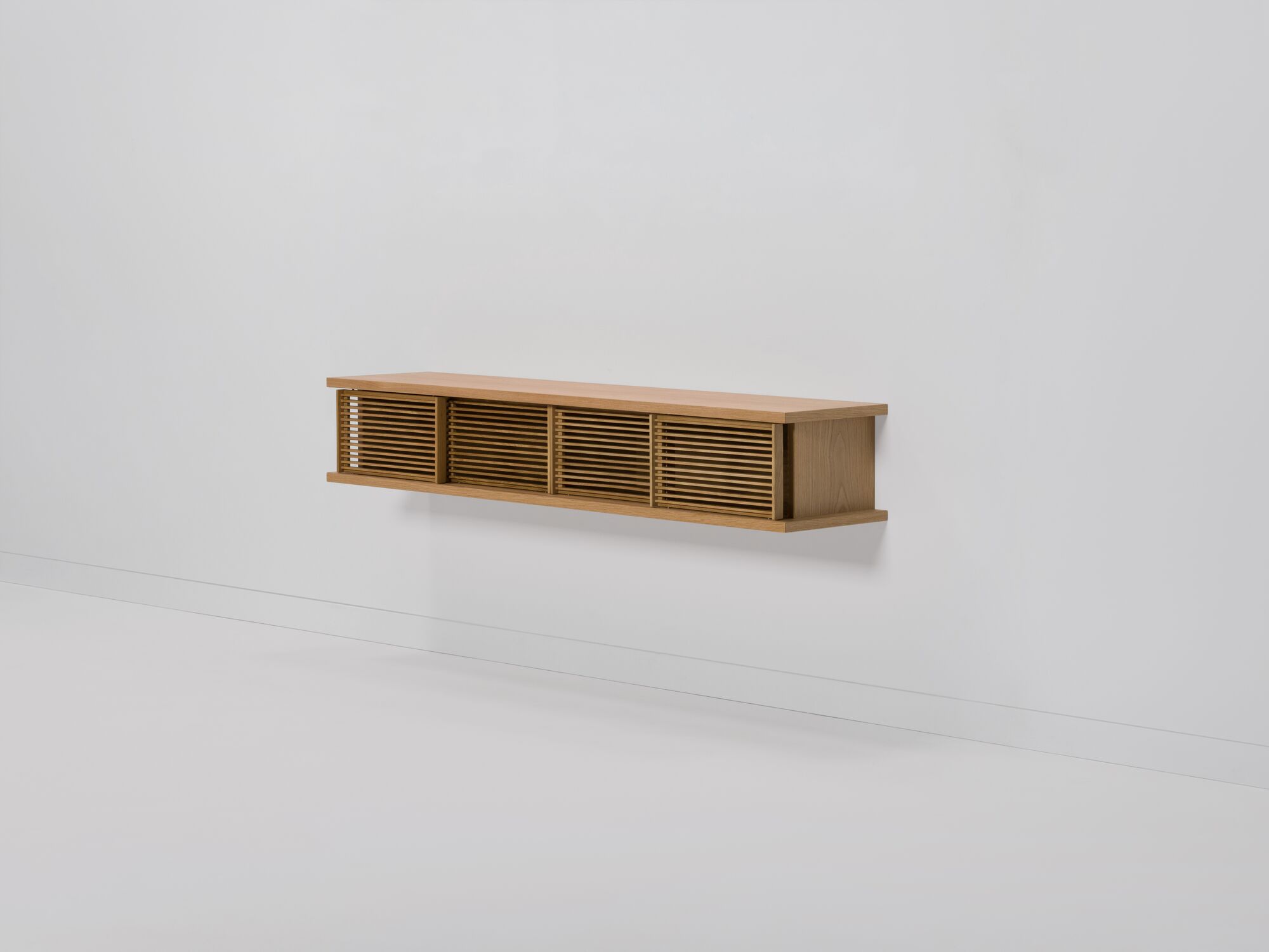 Medium oak floating media unit with slatted doors front angle view